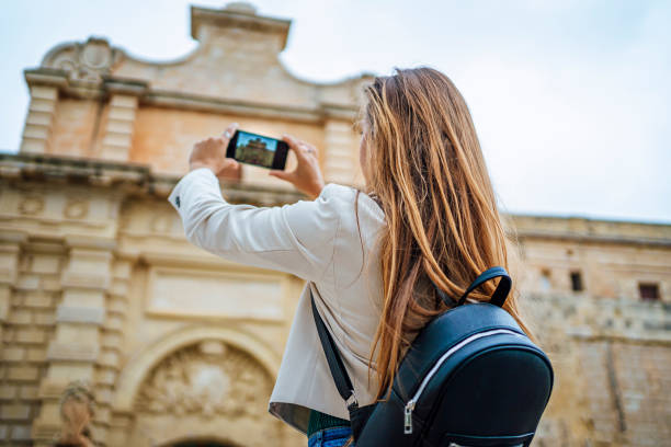 istock Young woman taking photos in Mdina, Malta 1496440304
