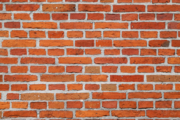 istock Texture of an old damaged orange brick wall as an architectural background 1496443417