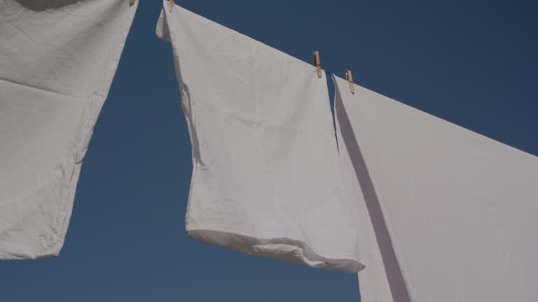 Sheets hanging to dry on a laundry line