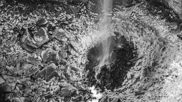 At Fall Creek Falls, TN, a waterfall cascades into a crater surrounded by fresh snow