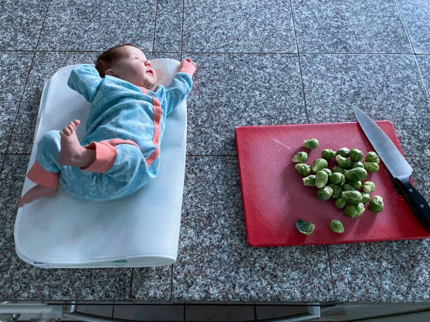istock Preparing dinner with a newborn baby 1496444184