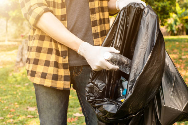 istock Closeup image of a hand picking up trash on World Environment Day,  showcasing our dedication to cleaning and protecting our planet. 1496447305