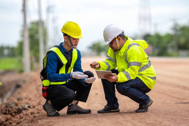 istock Asian engineer and foreman, checking road surface quality, holding tablet to inspect work, to supervise road construction, against the background of road under construction 1496447987