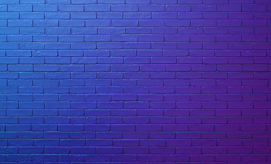 Neon colored lights on the old brick wall background