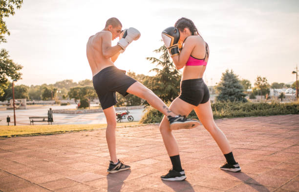 istock Young woman practicing boxing with her boyfriend 1496450554