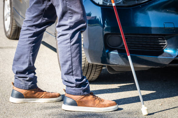 istock blind person with cane walking in front of car, Concept, Disability issues, Accessibility standards, Safety of people with disabilities 1496450652