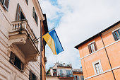 Ukrainian flag waving in the wind in Rome, Italy. National flag of Ukraine. Italy in solidarity with Ukrainian nation during the war, Russia invasion.