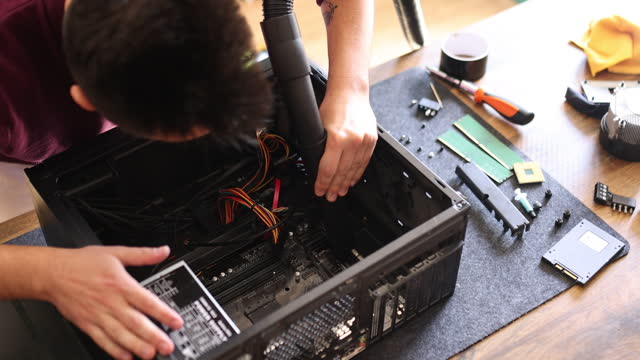 Computer specialist cleaning and repairing computer
