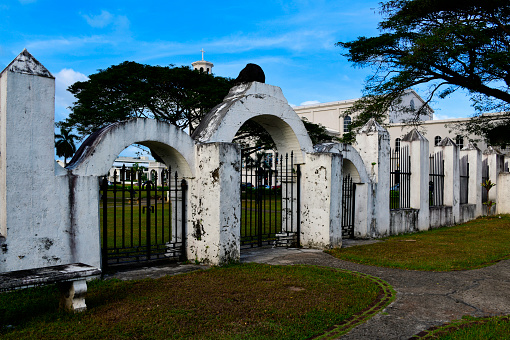 Hagåtña / Agana, Guam: Plaza de España -  location of the Governors Palace for centuries of Spanish presence - three-arch gate to ancient Almacén (military warehouse). Guam Catholic Cathedral in the background.