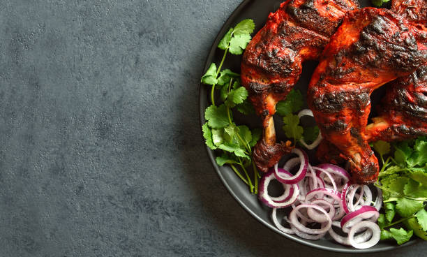 istock Tandoori chicken served with cilantro and onion 1496454282