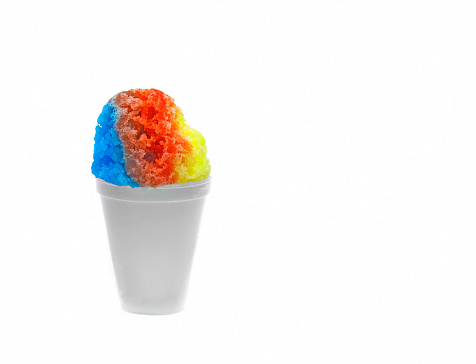 Hawaiian Rainbow shaved ice, shave ice, or snow cone dessert in a white cup with a white background.