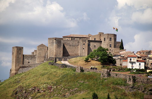 Melfi, Province of Potenza, Italy - 3 june 2023: The castle of Melfi, with its imposing Norman-Swabian silhouette, is the symbol of the city located on the slopes of Monte Vulture and its history is linked to the prominent figures who have succeeded one another over the centuries. Wanted by Roberto il Guiscardo, enlarged by Federico II, equipped with new towers by Charles I of Anjou, remodeled by the Caracciolos and the Dorias, to see it, the castle of Melfi almost seems to emerge on the top of a hill and one cannot fail to share the opinion of those who consider it the most famous castle in Basilicata and one of the largest in southern Italy.