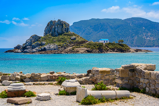 Ruins of the Basilica St. Stefanos in front of beautiful Island Kastri - beautiful coast scenery of Kos, Greece