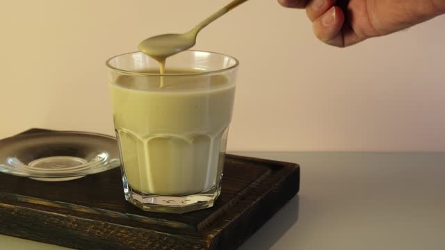 Glass of Popular Indian drink Karak tea or Masala chai. Prepared with the addition of milk, variety of spices and spices