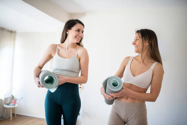 istock Women exercise yoga together. 1496463746