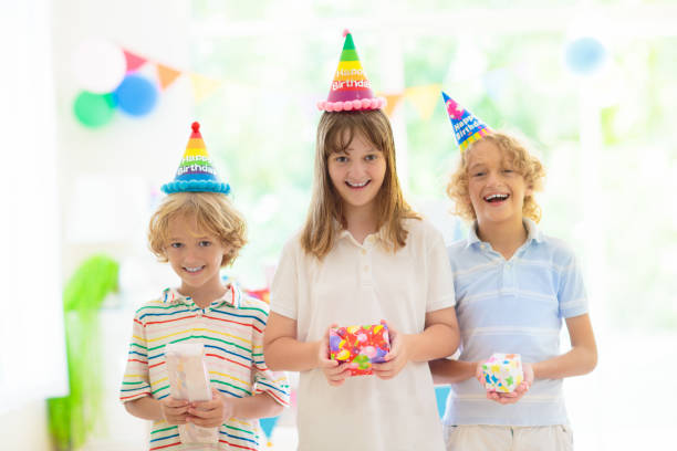 istock Kids birthday party. Child opening present. 1496466140