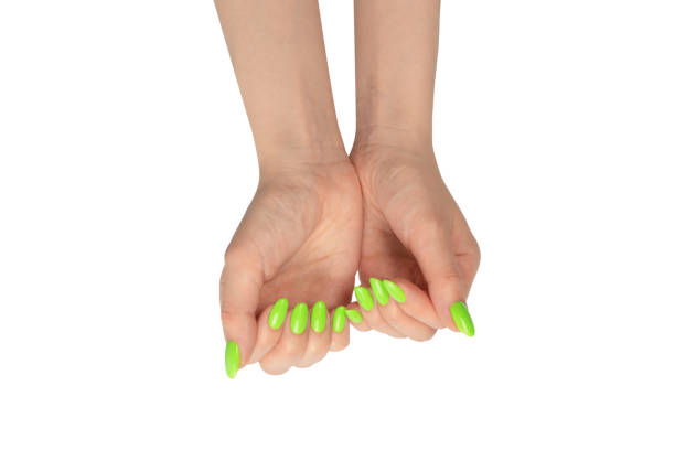 istock Hand of a woman with green naols hold some tiny or thin object. 1496466805