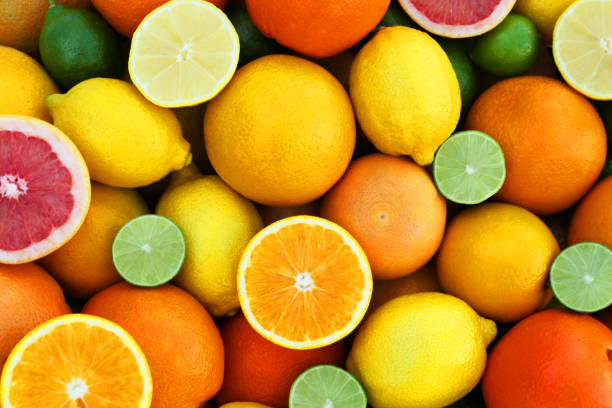 istock Many different whole and cut citrus fruits as background, top view 1496471246
