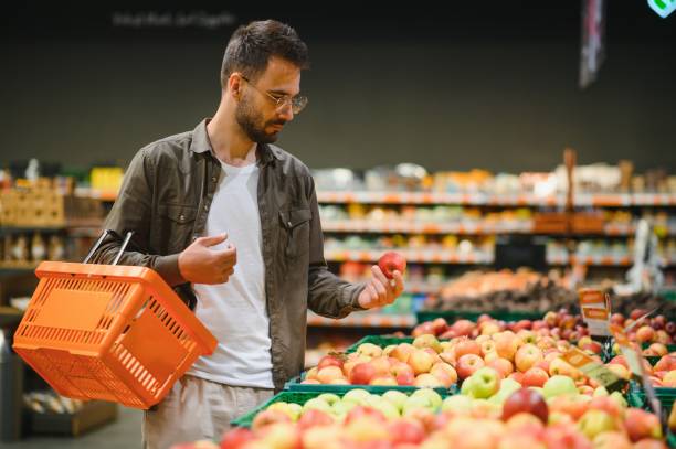 istock Handsome man shopping in a supermarket 1496471698
