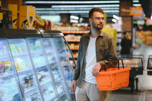 istock Handsome man shopping in a supermarket 1496472735