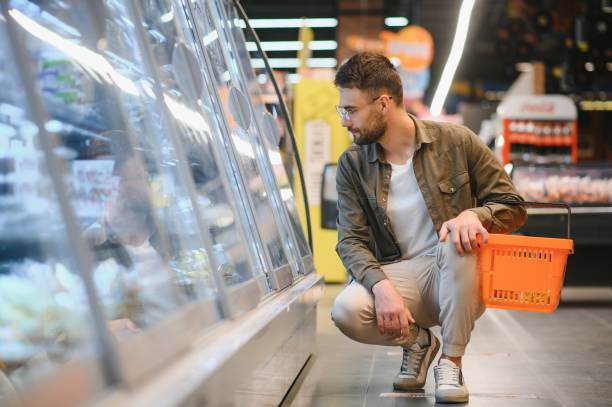 istock Handsome man shopping in a supermarket 1496472750