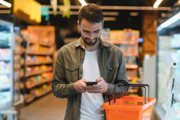 istock Handsome man shopping in a supermarket 1496472843