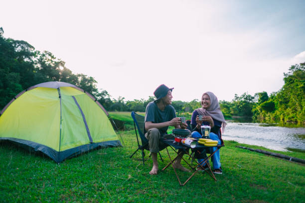 istock Happy asian couple camping together. 1496473007