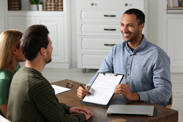 istock Notary showing contract to couple in office 1496473555