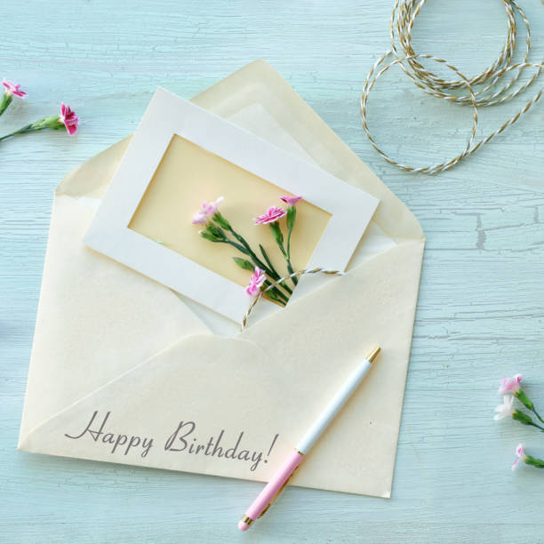 istock Envelope and self made greeting card concept with fresh carnation flowers. 1496475175