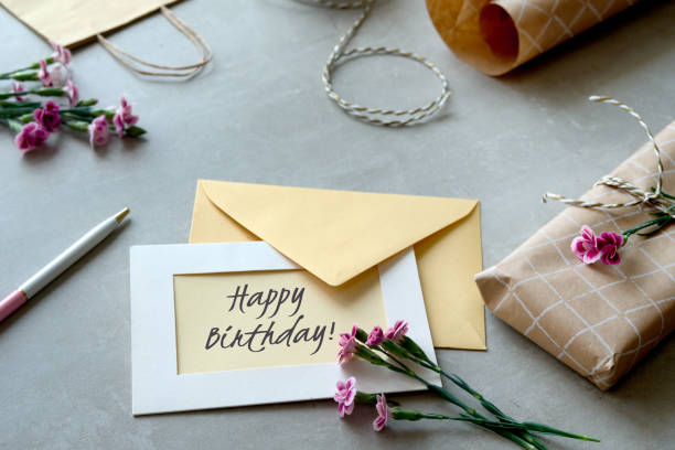 istock Envelope and self made greeting card concept with fresh carnation flowers. 1496475180