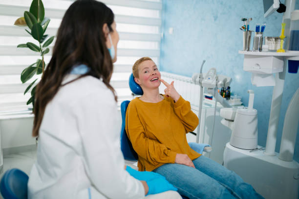 istock Young woman having a consultation with her dentist 1496476384