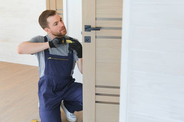 istock handsome young man installing a door in a new house construction site. 1496476564