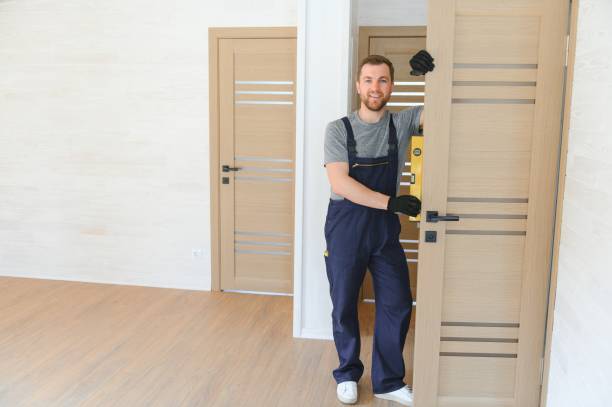 istock handsome young man installing a door in a new house construction site. 1496477185
