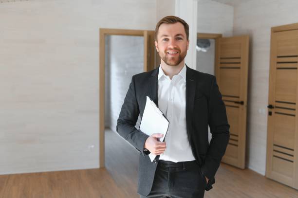 istock Estate Agent Looking Around Vacant Property For Valuation 1496477449