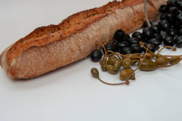Rye homemade bread with olives and capers on a white background isolated.
