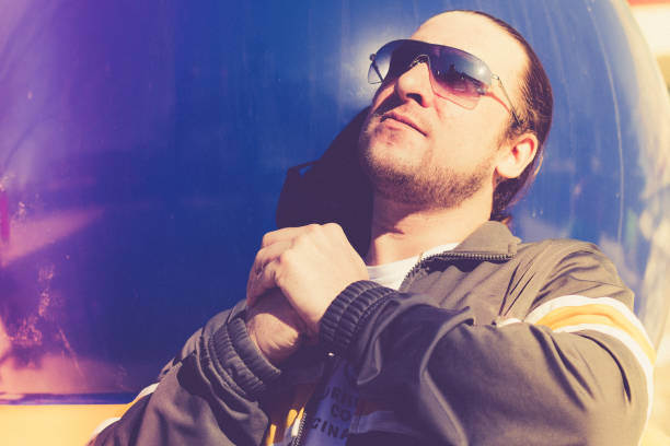 Captivating shot of a hardcore rapper, where the burnt film edit enhances the grit and style of the scene, elevating the street persona and emphasizing the artist's magnetic presence.