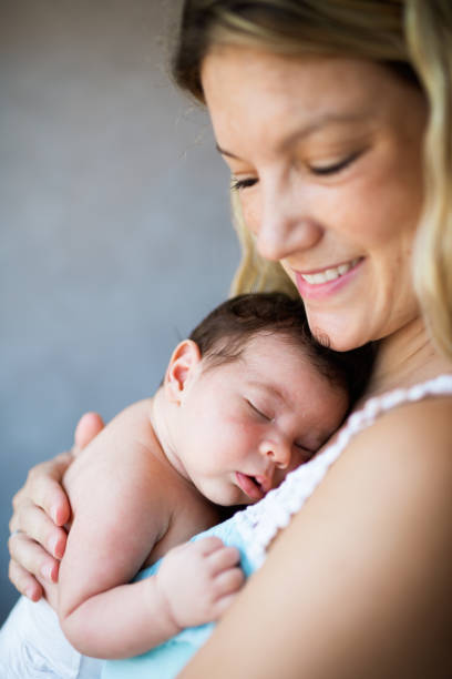 istock Newborn baby in mother's arms 1496478190