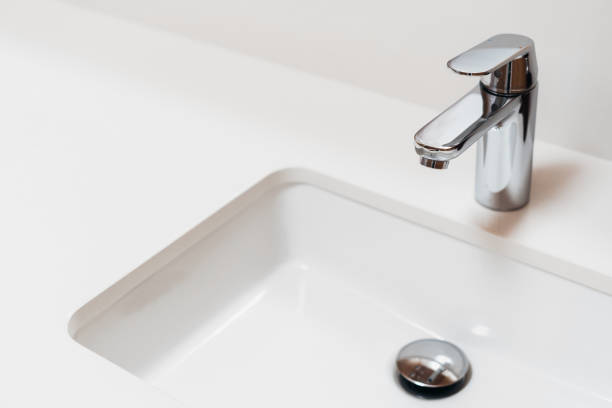 white modern sink and chrome faucet in bathroom