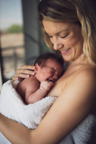 istock Newborn baby in mother's arms 1496478241