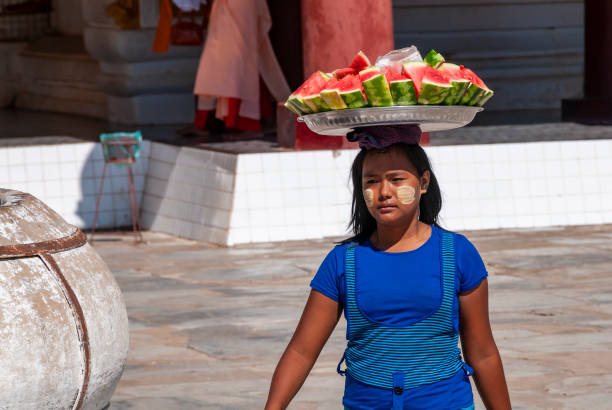 Nyaung U, Bagan, Myanmar- nov 6, 2012 : a woman sells sliced watermelon in the courtyard of the Shwezigon temple in Nyaung U, near Bagan