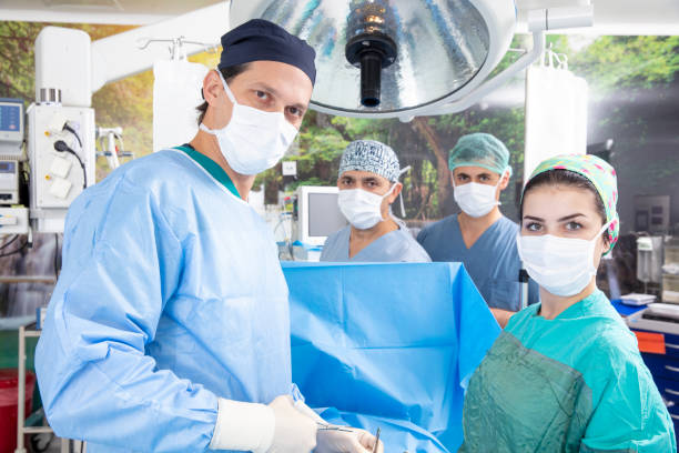 istock Doctor and his assistants in a modern operating room 1496481823