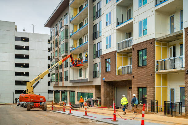 Construction workers work on a new condo development in Charlotte, North Carolina, USA  on an overcast day.