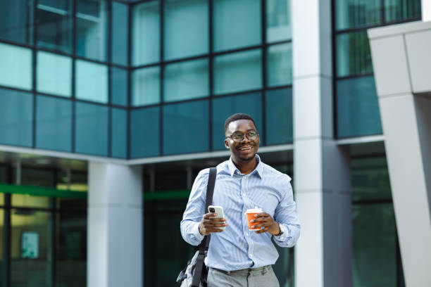 istock African American businessman ealking and using smart hpone 1496484057