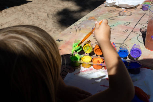 istock Girl using paints to paint the most beautiful landscape. 1496484337