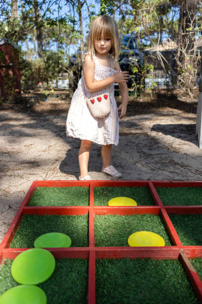 istock Small girl having fun while playing alone outdoors. 1496484420