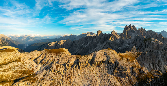 Captivating Aerial View of Tre Cime di Lavaredo's Mountain Massif Bathed in the Warm Glow of Sunset