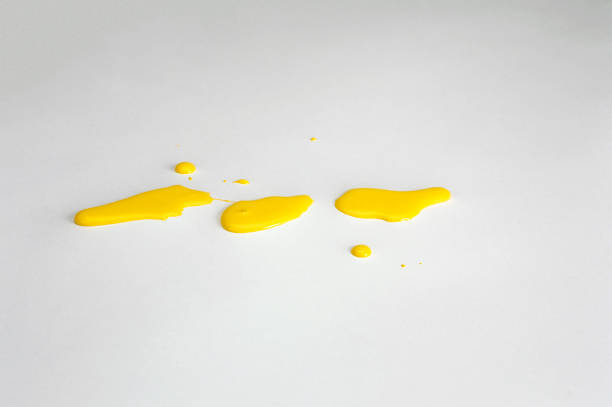 istock Yellow paint droplets on a white background. 1496490383
