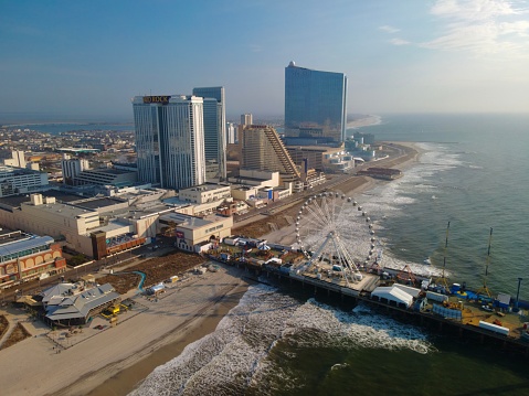 Gorgeous aerial shot along boardwalk and shore in Atlantic City, NJ
