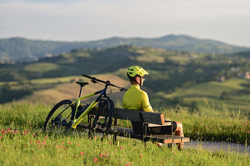 Cyclist enjoying the view of hills.