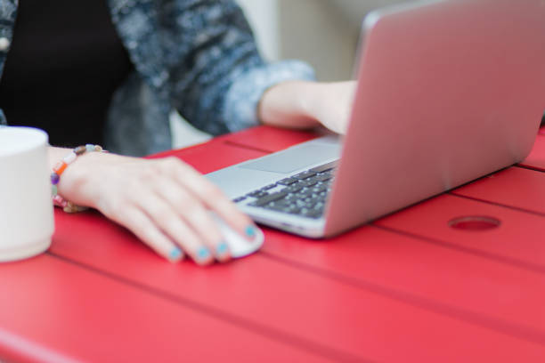 istock Woman using a laptop in a bar 1496492695